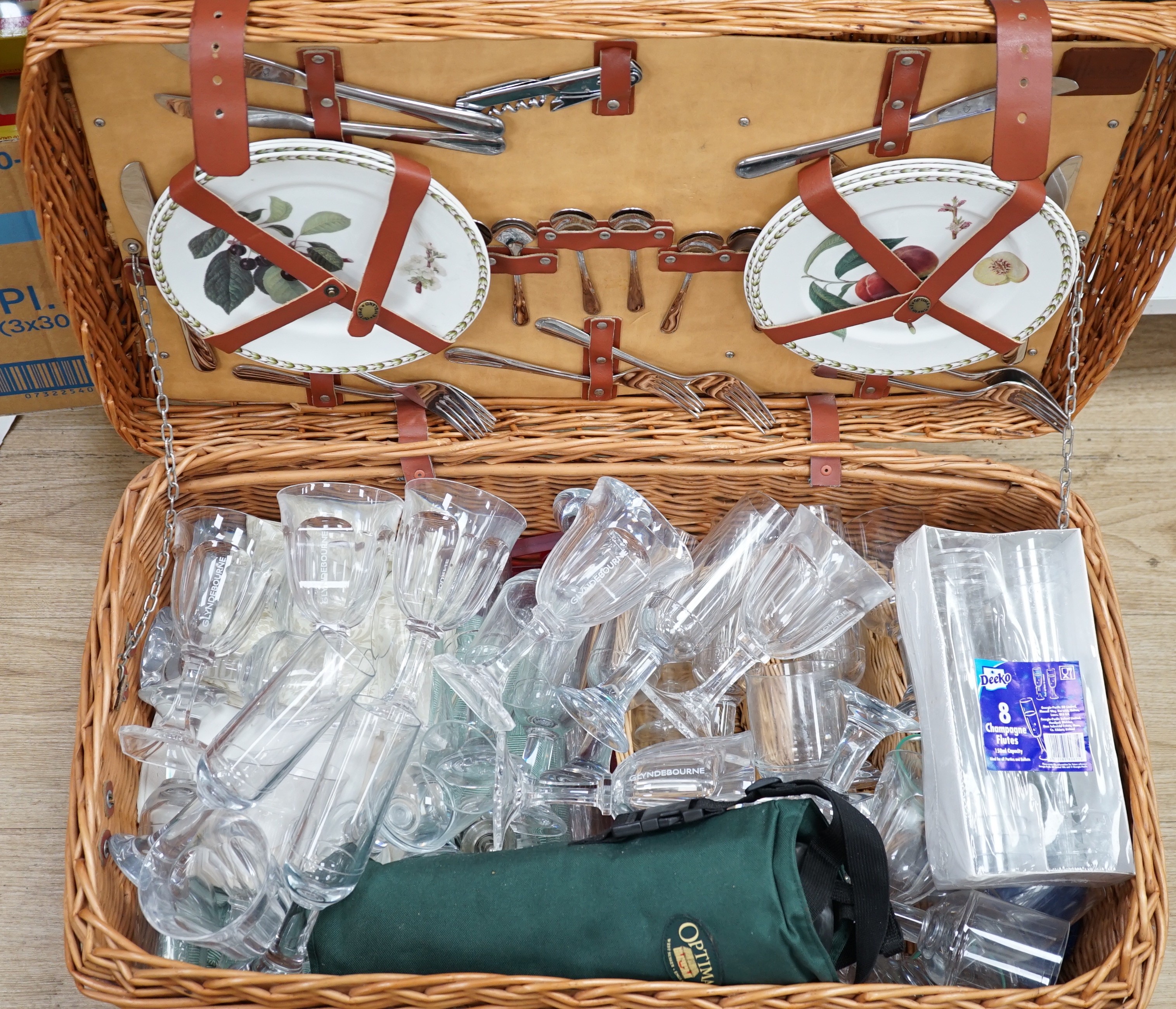 A wicker picnic hamper with assorted Glyndebourne plastic goblets, hamper 72cms wide x 39cms deep